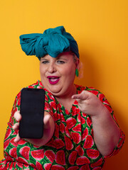 Plus size woman pointing at smartphone with excitement