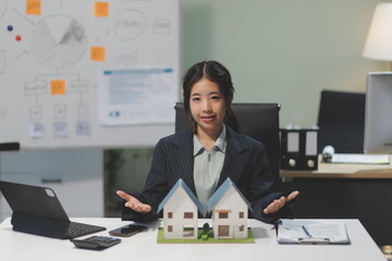 Real estate agents explain models of housing estates in projects to elaborate to clients,...