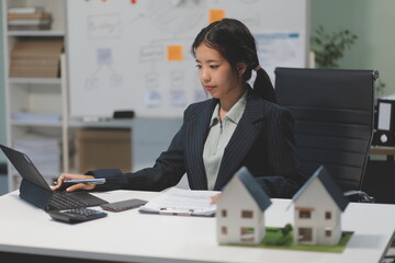 Real estate agents explain models of housing estates in projects to elaborate to clients,...