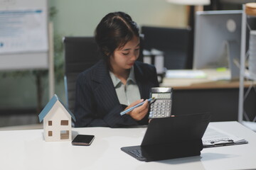 Real estate agents explain models of housing estates in projects to elaborate to clients,...