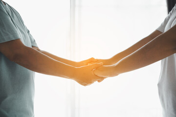 Hope and trust with crisis concept. Closeup, love and holding hands for support, comfort and care with grief, loss and empathy. people and family with compassion, sympathy and healing with bonding.