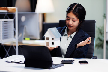 Real estate agents explain models of housing estates in projects to elaborate to clients,...