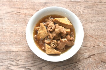 boiled braised slice pork innards and tofu in black Chinese herb soup on bowl