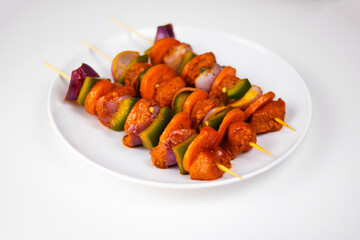 Raw Chicken Kebab with vegetable on plate in white background, Raw Chicken Shashlik on plate