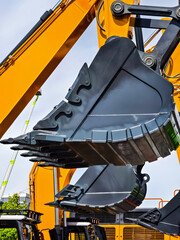 Excavator bucket close-up showcased during construction in an industrial site