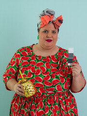 Playful Woman with Golden Pineapple Cup Wearing Watermelon Dress