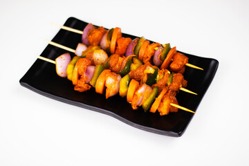 Raw chicken shashlik with pepper onion carrot on plate in white background, Raw chicken kebab on...