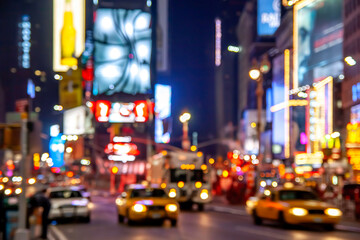Conceptual image of the city that never sleeps, New York, showcasing its famous billboards at Times Square in a defocused photo.
