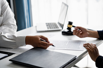 serious courtroom lawyer preparing litigation documents for business client before official hearing