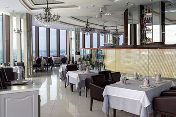 Interior of luxury restaurant in a classic style with panoramic windows