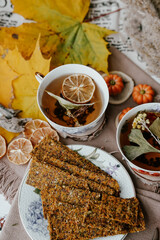 Cozy autumn vibes with herbal tea, homemade bread, dried citrus slices, and seasonal decor – a perfect setting for relaxation and warmth.