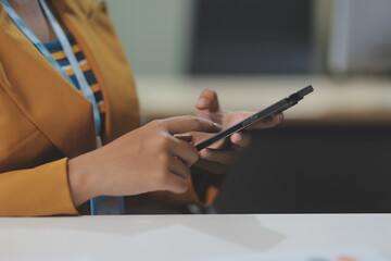 Asian businesswoman in formal suit in office happy and cheerful during using smartphone and working