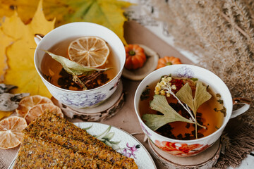 Cozy autumn vibes with herbal tea, homemade bread, dried citrus slices, and seasonal decor – a perfect setting for relaxation and warmth.