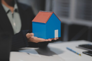 Real estate agents explain models of housing estates in projects to elaborate to clients,...