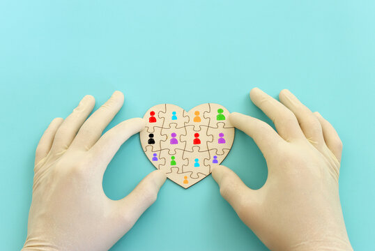 Top view image of doctor or nurse with gloves and puzzle pieces over blue background