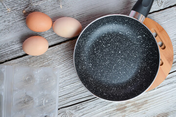 Making breakfast - frying eggs in the small pan.