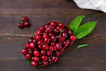 rustic style image of bowl with cherries on wooden background