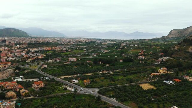 Top-down aerial shot of intersecting streets in Porticello near Palermo, showing Mediterranean-style homes, parked cars, and urban patterns in a quiet residential district