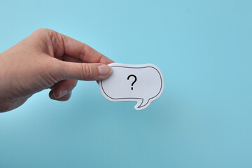 The question mark in a person's hand, the concept of questions and answers