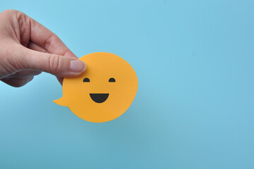 Speech balloons with a happy smiley face, positivity, optimism and joy of life