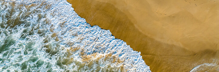 Florianópolis, Campeche beach during sunrise. Brazil. Rio Tavares neighborhood. Wave formation in web banner aerial view.