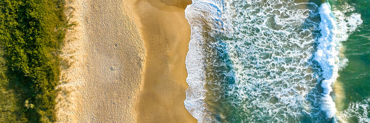 Florianópolis, Campeche beach during sunrise. Brazil. Rio Tavares neighborhood. Wave formation in web banner aerial view.