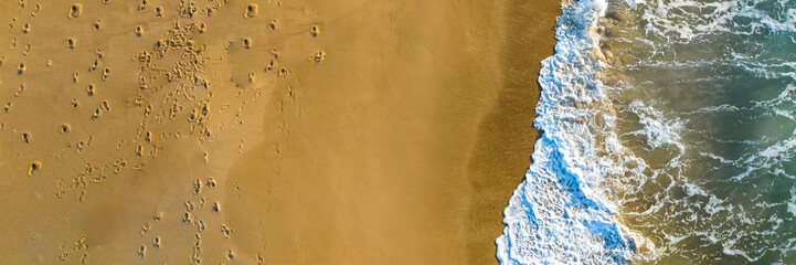 Florianópolis, Campeche beach during sunrise. Brazil. Rio Tavares neighborhood. Wave formation in web banner aerial view.