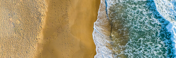 Florianópolis, Campeche beach during sunrise. Brazil. Rio Tavares neighborhood. Wave formation in web banner aerial view.