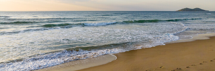Florianópolis, Campeche beach during sunrise. Brazil. Rio Tavares neighborhood. Wave formation in web banner.