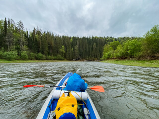 A person is actively paddling a kayak down a winding river, enjoying the serene surroundings and the thrill of navigating the water. Its a wonderful outdoor recreation experience