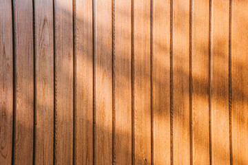 Obraz premium Wood background. Close-up Texture of Natural Wood Panels with Warm Tones and Soft Shadows Creating a Cozy Atmosphere in Interior Design