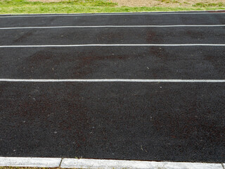 A black and white photo of a track with white lines