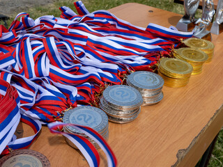 A table with a bunch of medals and ribbons on it