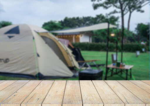 Wooden table top on camping ground mountain and grass field.Fresh and Relax concept.For montage product display or design key visual layout.View of copy space.