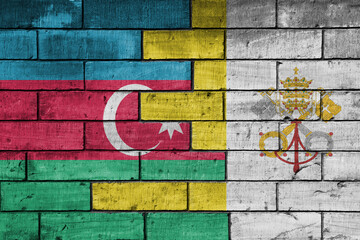 colourful painted big national flag of vatican city and flag of azerbaijan on a massive old brick wall background. concept