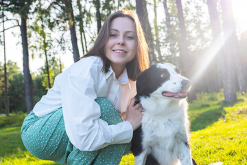 woman and her dog. A bob-haired girl in a white shirt and green skirt walks with her dog amid Norwegian greenery — a warm moment of tenderness, harmony, and unity with nature.