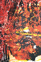 Thick red black and yellow paint in a scribbled abstract background