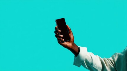 Professional product photo of a human hand gripping a sleek smartphone on a vibrant teal background