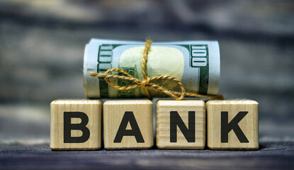 BANK text word concept on cubes with a Banknote dollar money. Business concept
