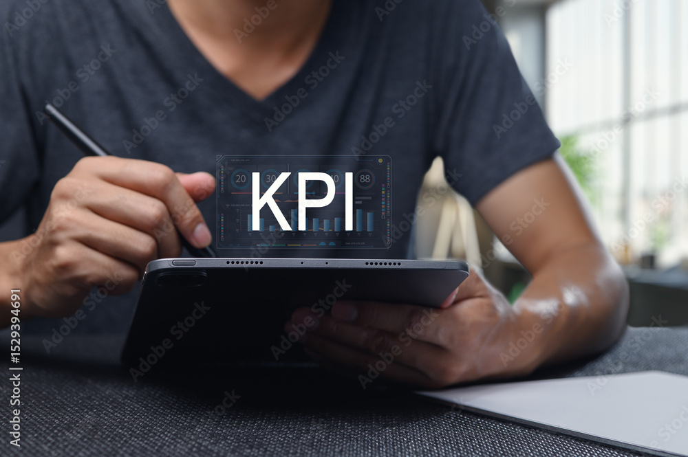 Aufkleber analyzing key performance indicators on digital tablet for business insights