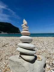 Balanced Stone Tower on a Pebble Beach under Clear Blue Sky