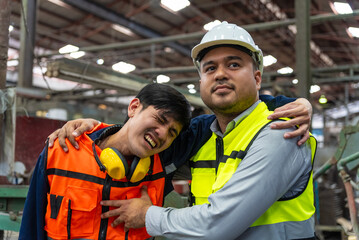 Obraz premium Professional asian man engineer working in warehouse, emergency during work in factory resulting in injury, safety and security in factory industry.