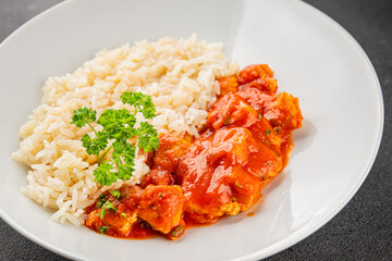 Rice butter chicken curry chicken tikka masala spicy meat in a bowl on the table fresh tasty gourmet food background on rustic food top view copy space