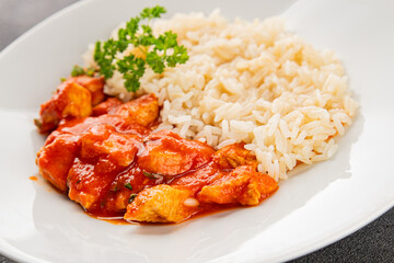Rice butter chicken curry chicken tikka masala spicy meat in a bowl on the table fresh tasty gourmet food background on rustic food top view copy space