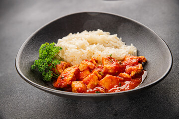 Rice butter chicken curry chicken tikka masala spicy meat in a bowl on the table fresh tasty gourmet food background on rustic food top view copy space