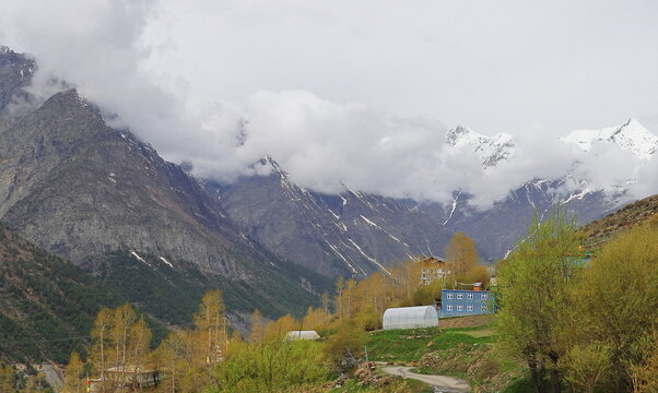 panoramic view of scenic snowcapped himalaya mountains and beautiful landscape of remote mountain village of lahaul valley in himachal pradesh, india