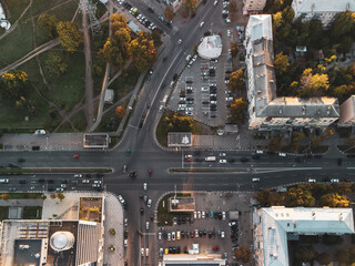 Aerial look down of urban transportation scene, lively intersection in city center with cars driving