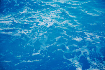 Vibrant blue ocean waves with gentle foam patterns