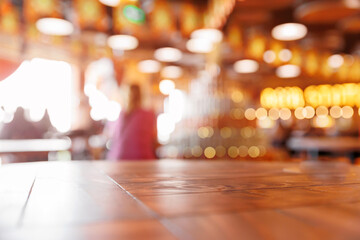 Blurred background interior of brewery factory with wooden table in foreground for copy space