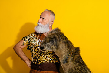 Photo of aged savage caveman wear leopard skin outfit animal coat isolated on yellow color background